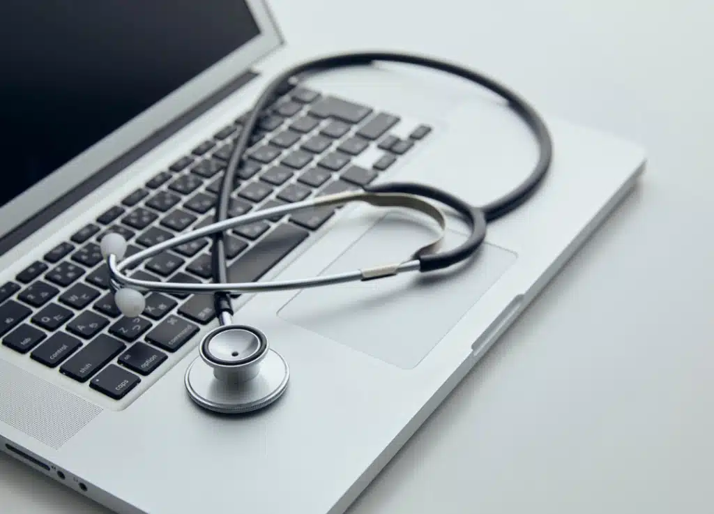 Stethoscope resting on laptop keyboard symbolizing digital transformation, healthcare technology integration, and data-driven growth for medical providers.