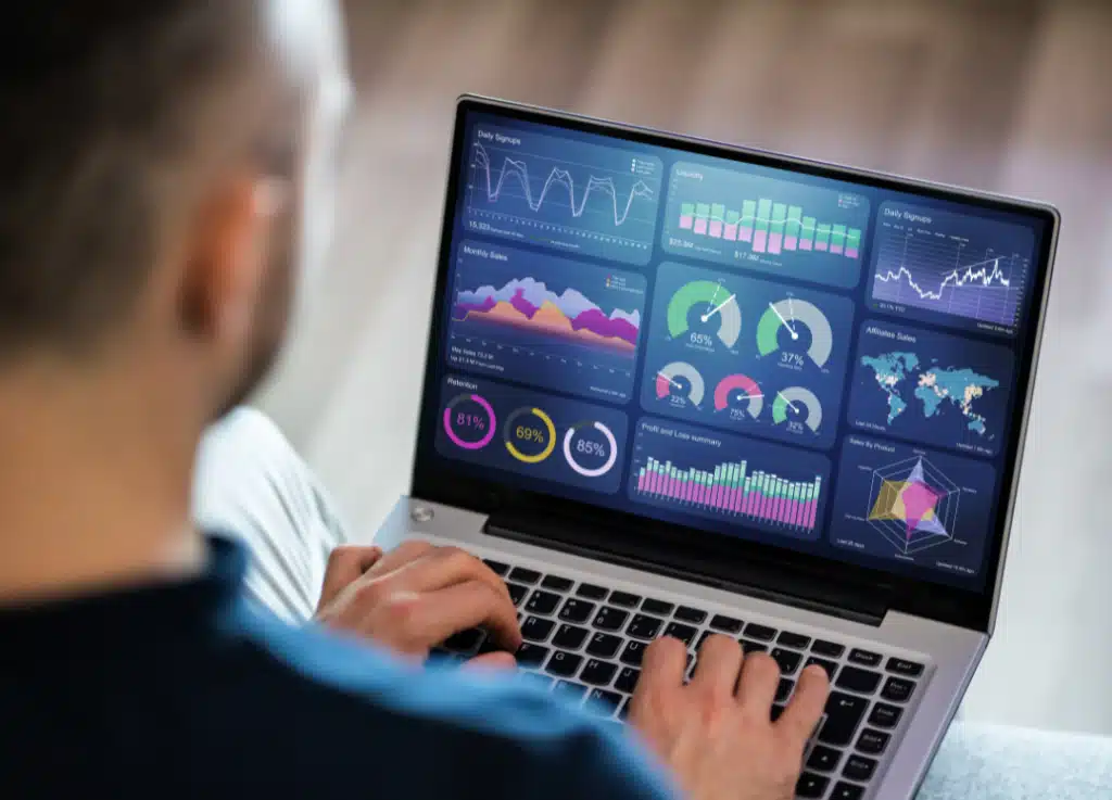 Private equity professional analyzing financial dashboards and performance metrics on a laptop, representing Strativera’s expertise in growth analytics and value creation strategies.