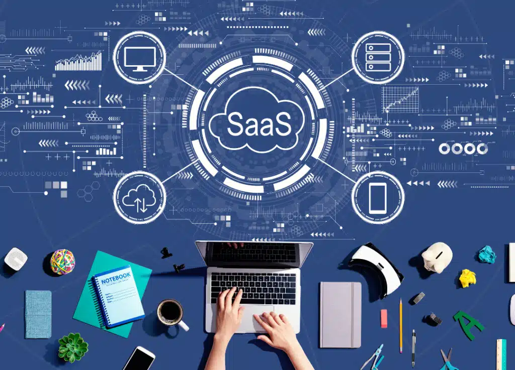 Top view of workspace with laptop and SaaS cloud illustration representing software-as-a-service strategy, digital transformation, and growth consulting by Strativera.